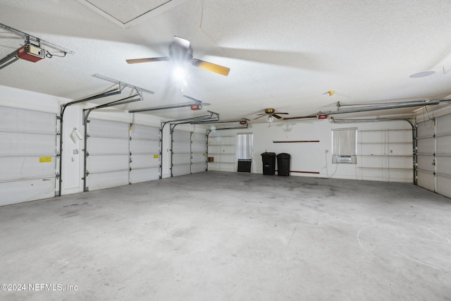 garage with a garage door opener and ceiling fan