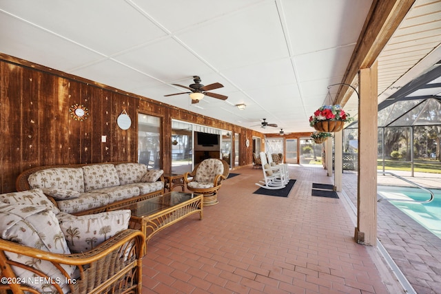 view of patio featuring glass enclosure and an outdoor hangout area