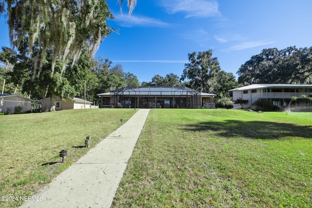 view of front of property featuring a front lawn and a lanai