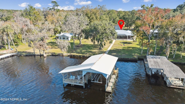 view of dock featuring a yard and a water view