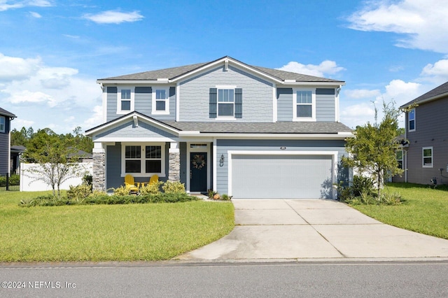 view of front of home featuring a garage and a front lawn