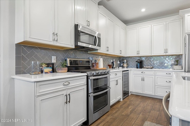 kitchen with white cabinetry, stainless steel appliances, wine cooler, and dark wood-type flooring