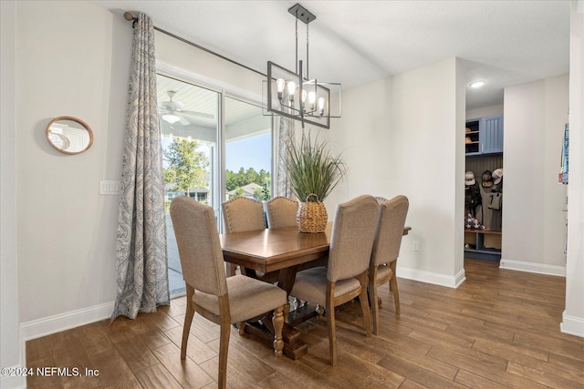 dining room with hardwood / wood-style flooring and a notable chandelier