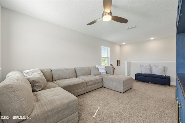 living room with carpet, a textured ceiling, and ceiling fan