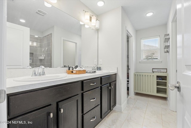 bathroom featuring vanity and a tile shower