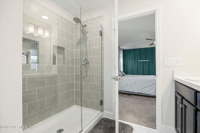 bathroom featuring ceiling fan, a shower with door, and vanity