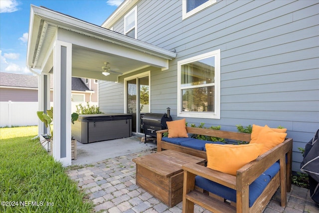 view of patio / terrace featuring an outdoor living space, a hot tub, and ceiling fan