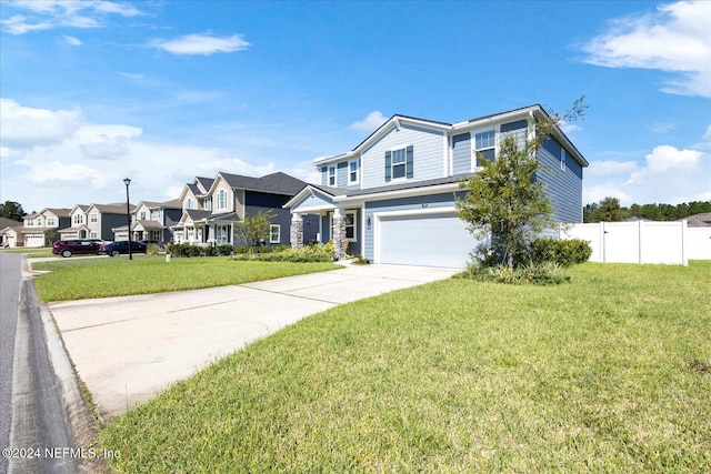 view of front of property featuring a front lawn and a garage