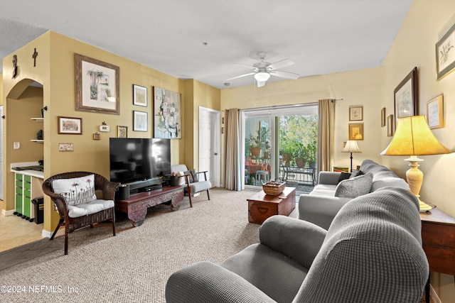 carpeted living room featuring ceiling fan