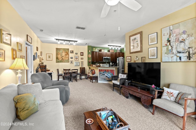 living room with light colored carpet, track lighting, and ceiling fan