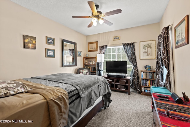 bedroom with carpet, ceiling fan, and a textured ceiling