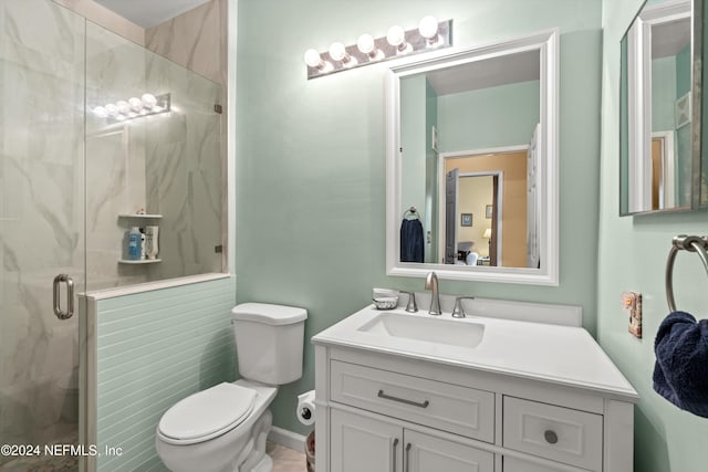 bathroom featuring vanity, toilet, and an enclosed shower