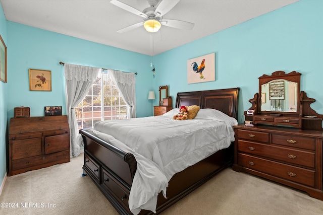 bedroom with ceiling fan and light carpet