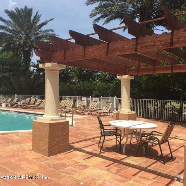 605 Fairway Dr Unit 205, Saint Augustine, FL 32084 - view of patio featuring a pergola and a community pool