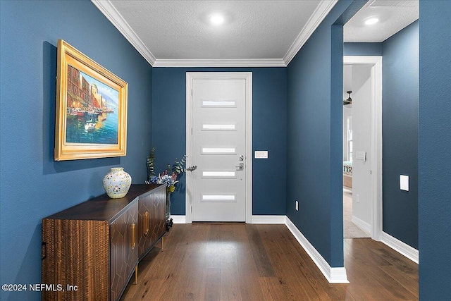 foyer entrance featuring hardwood / wood-style floors, a textured ceiling, and crown molding