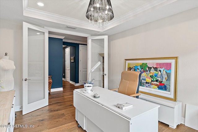 office space featuring hardwood / wood-style flooring, a chandelier, crown molding, and a tray ceiling