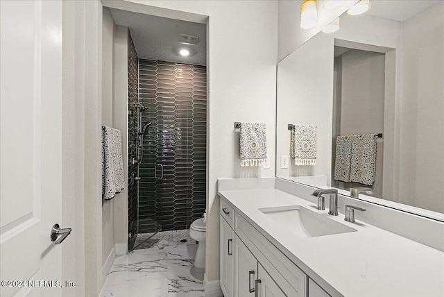 bathroom featuring tiled shower, vanity, and toilet