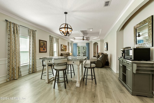 kitchen featuring light hardwood / wood-style flooring, ceiling fan with notable chandelier, coffered ceiling, and ornamental molding