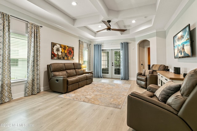 living room with a wealth of natural light, french doors, light hardwood / wood-style floors, and coffered ceiling