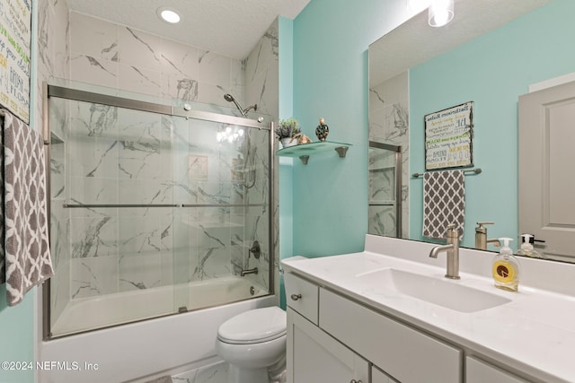 full bathroom featuring vanity, enclosed tub / shower combo, a textured ceiling, and toilet