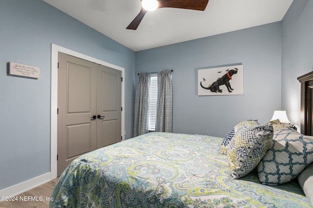 bedroom featuring light hardwood / wood-style flooring, a closet, and ceiling fan