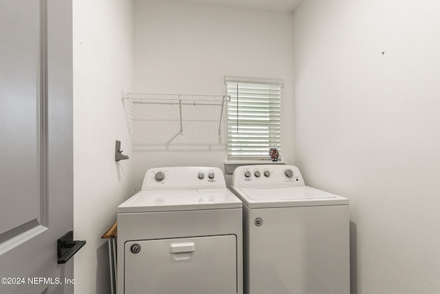 washroom with washing machine and clothes dryer