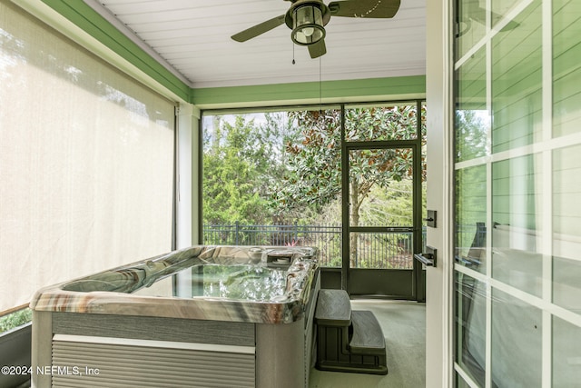 sunroom featuring a hot tub, plenty of natural light, and ceiling fan