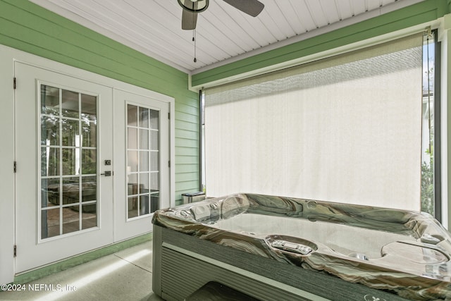 sunroom / solarium with ceiling fan and a hot tub