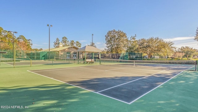 view of tennis court with a gazebo and basketball court