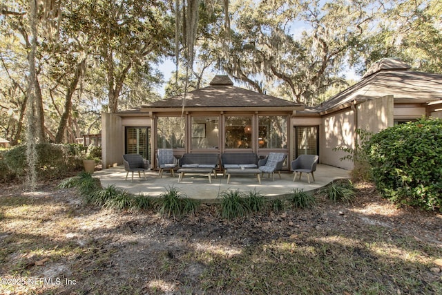 back of property with a patio