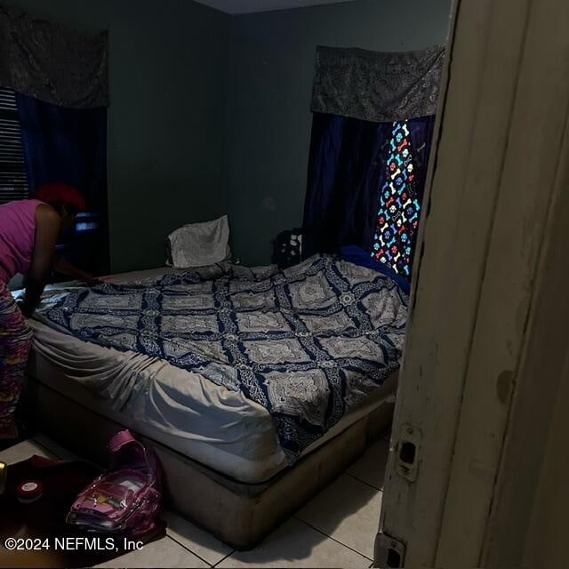 bedroom featuring light tile patterned floors