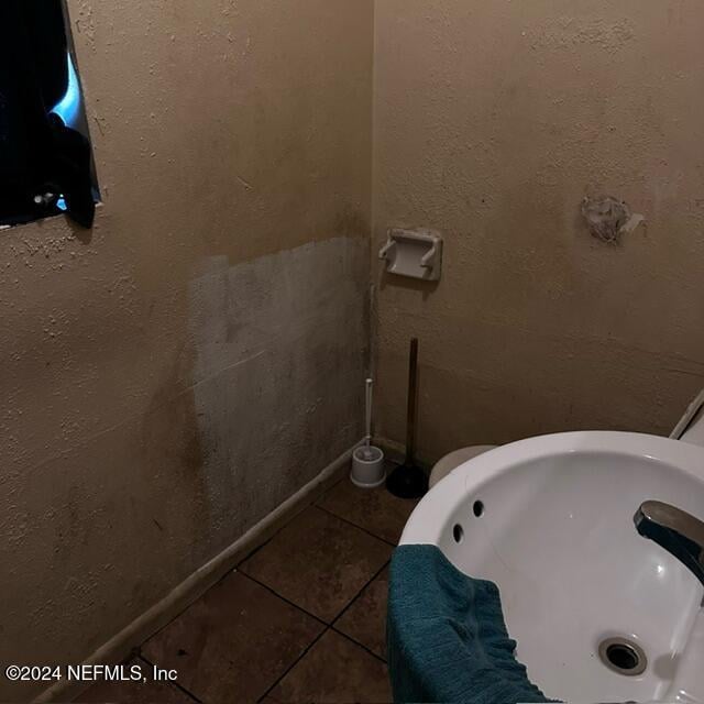 bathroom with tile patterned floors