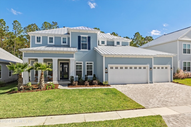 view of front of property featuring a garage and a front lawn