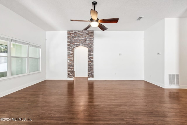 unfurnished living room featuring ceiling fan, dark hardwood / wood-style flooring, and a textured ceiling