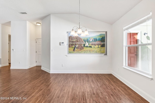 unfurnished dining area featuring dark hardwood / wood-style flooring, an inviting chandelier, and lofted ceiling