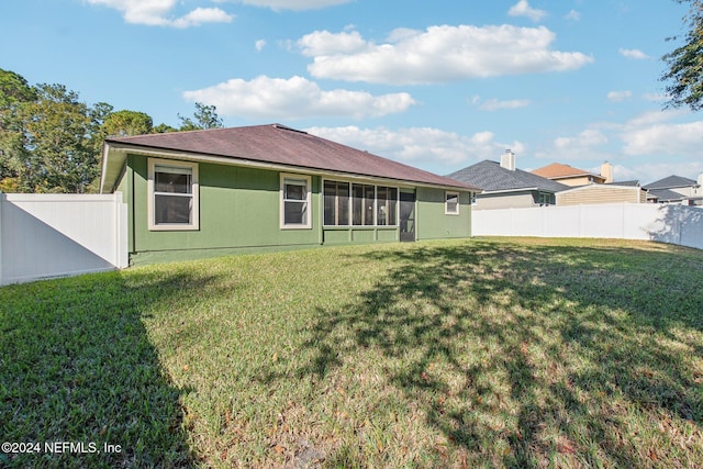 rear view of house with a lawn