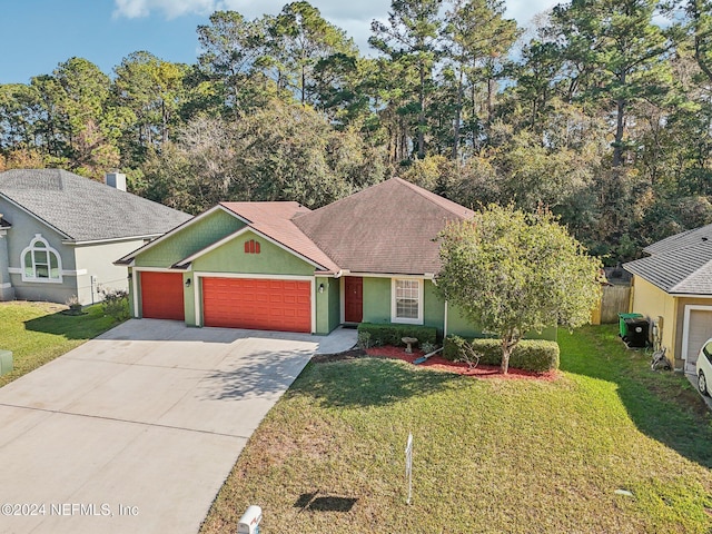 view of front of property featuring a front yard and a garage