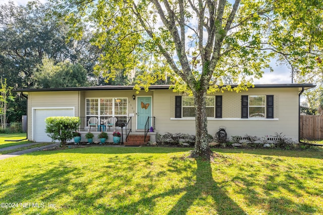 single story home featuring a front lawn and a garage