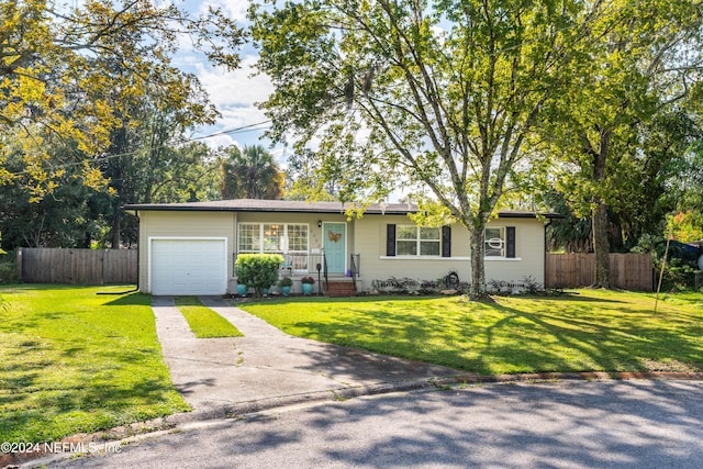 ranch-style home featuring a porch, a garage, and a front lawn