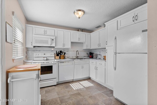 kitchen featuring white cabinets, white appliances, sink, and tasteful backsplash