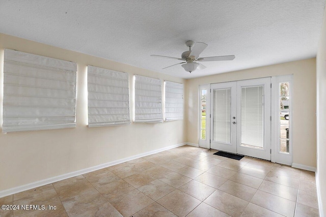 foyer with french doors, a textured ceiling, ceiling fan, and light tile patterned flooring