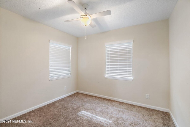 unfurnished room featuring ceiling fan, carpet floors, and a textured ceiling