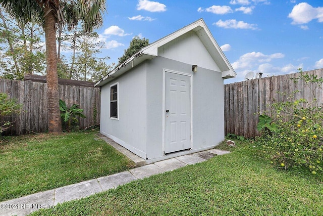 view of outbuilding with a lawn