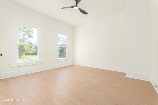 spare room featuring ceiling fan, ornamental molding, and light hardwood / wood-style flooring