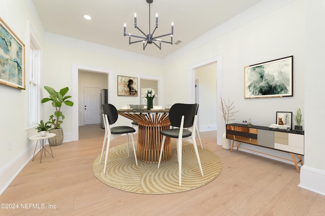 dining area featuring light hardwood / wood-style floors and a chandelier