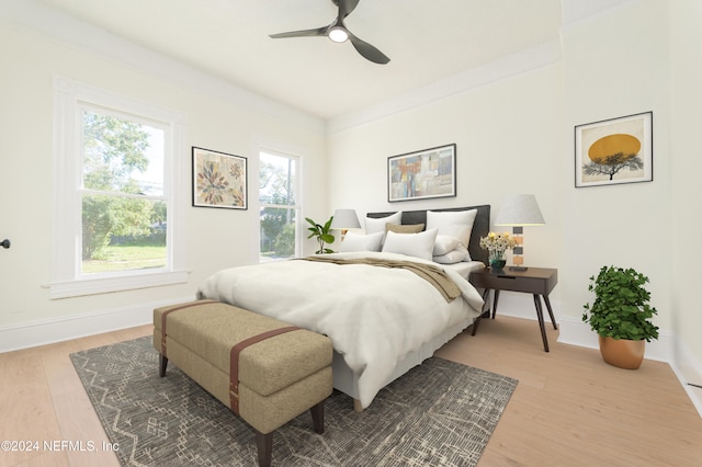 bedroom with hardwood / wood-style floors, ceiling fan, and crown molding