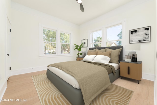 bedroom with light wood-type flooring and ceiling fan