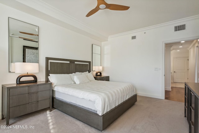 carpeted bedroom featuring ceiling fan and ornamental molding