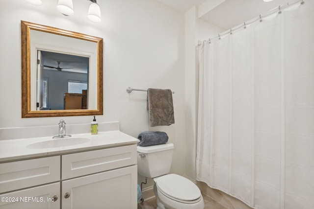 bathroom featuring vanity, ceiling fan, and toilet