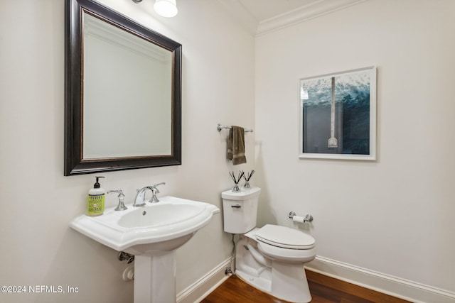 bathroom featuring crown molding, wood-type flooring, and toilet